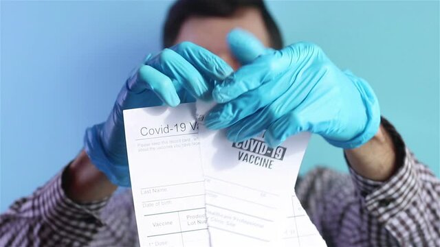 Close Up Of Man In Protective Mask Ripping Covid 19 Vaccination Card Coronavirus Anti Vaccine Concept