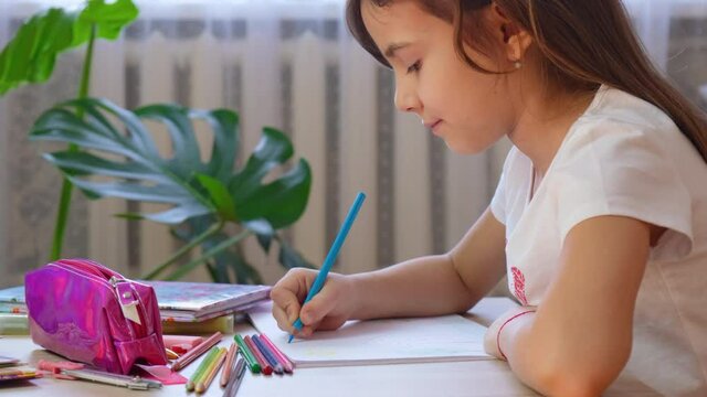 child girl draws with pencils. selective focus.