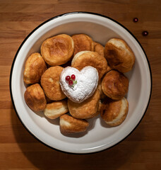 Fried yeast dough donuts on a wooden table