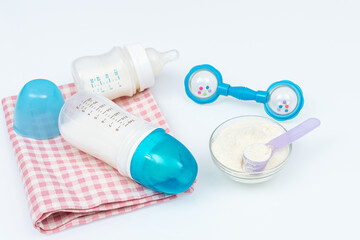 Feeding baby accessories - bottles on fabric, spoon with formula and beanbag