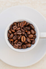 Coffee cup and beans on a white background. Top view with copy space for your text
