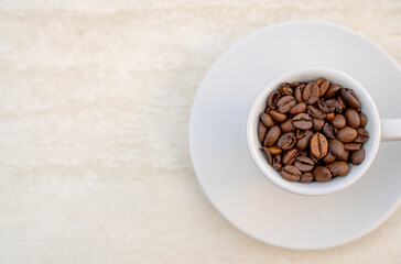 Obraz na płótnie Canvas Coffee cup and beans on a white background. Top view with copy space for your text