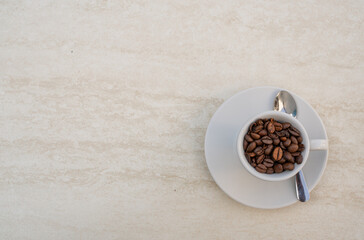 Coffee cup and beans on a white background. Top view with copy space for your text