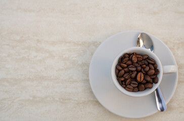 Coffee cup and beans on a white background. Top view with copy space for your text