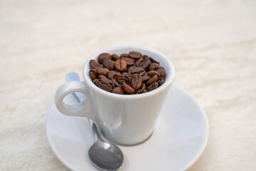 Coffee cup and beans on a white background. Top view with copy space for your text
