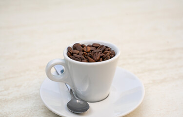 Coffee cup and beans on a white background. Top view with copy space for your text