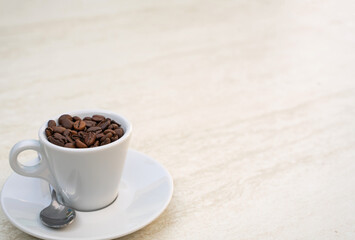 Coffee cup and beans on a white background. Top view with copy space for your text