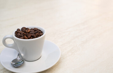 Coffee cup and beans on a white background. Top view with copy space for your text