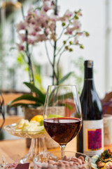 Wine concept. Summer and spring mood. Glass of wine and flowers