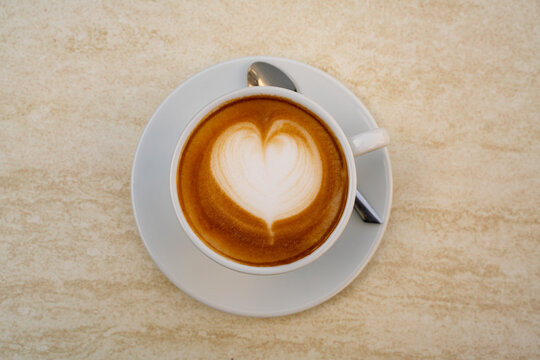 Background image of cappuccino in a cup with coffee beans