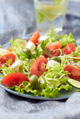 Salad with Green Olives, Tomatoes and Feta Cheese. Bright background. 