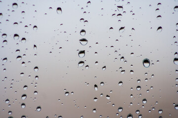 Drops of rain on the window or glass. Gray wet glass pattern texture. Abstract
