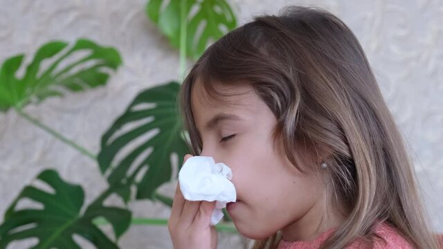 child girl wipes a runny nose with a napkin snot. selective focus.