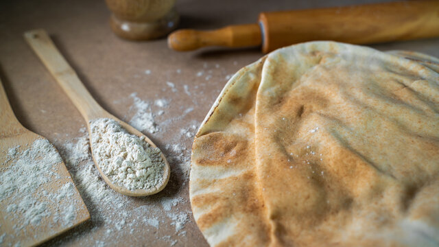 Kuboos or khubz - Arabic bread on a brown table in the kitchen