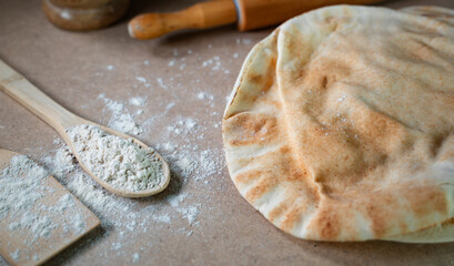 Kuboos or khubz - Arabic bread on a brown table in the kitchen