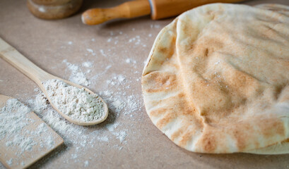 Kuboos or khubz - Arabic bread on a brown table in the kitchen