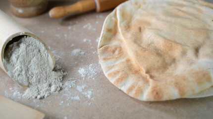 Kuboos or khubz - Arabic bread on a brown table in the kitchen