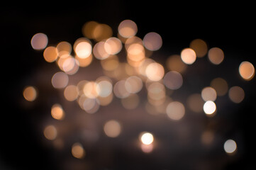 gold bokeh of different transparency on a black background