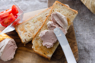 朝食で食パンにレバーペーストを塗る