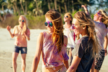 multinational multicultural mixed race friends in holi dust on beach in Goa