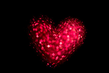 Red glowing heart on a black background. Happy Valentine's Day