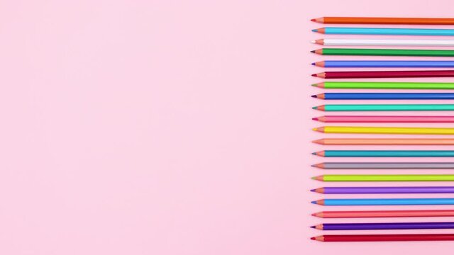 Pencils in different colors appear on right side of pastel pink theme. Stop motion