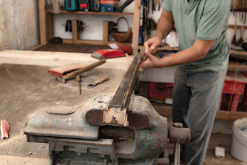 Male carpenter working on old wood in a retro vintage style.
