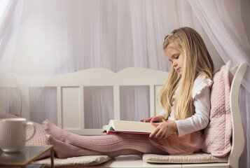Little girl reading book. 