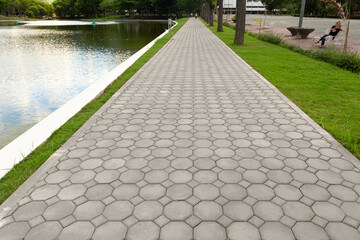 Paver brick floor also call brick paving, paving stone or block paving. Made from concrete or stone for road, path, driveway and patio. Empty floor in perspective view for texture background. - obrazy, fototapety, plakaty