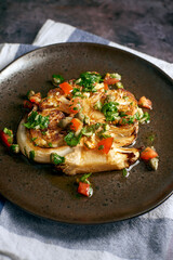 Cauliflower Steak on a dark plate