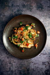 Cauliflower Steak on a dark plate shot from overhead