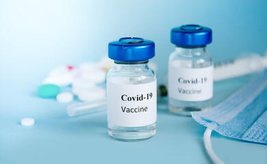 Coronavirus vaccine COVID-19 on a blue background close-up. Vaccine Concept of fight against coronavirus.