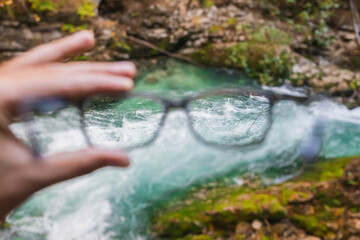 seething mountain river in Slovenia through glasses