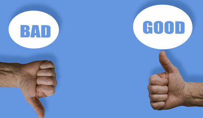 Two hands thumbs up and down good & bad text blue background.