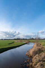 Canal trhought green meadow