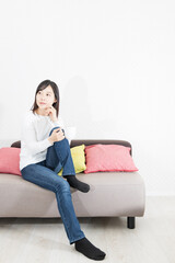 Woman drinking coffee on the couch