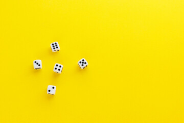Five dice showing different sides on yellow background. Playing cube with numbers. Items for board...