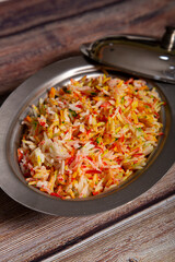 Basmati rice cooked with spices and vegetables on wooden background. selective focus / Indian vegetarian food.