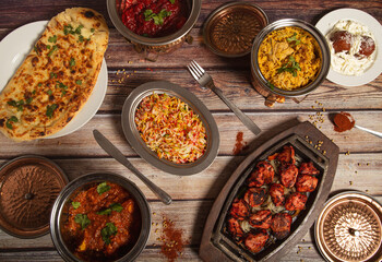 Assorted Indian dishes of rice and curry on wooden background. Top view