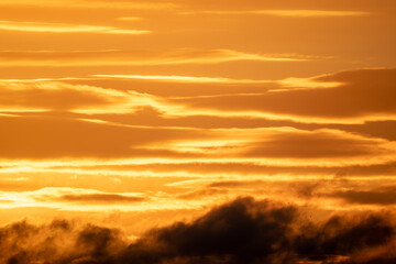 Winter sky at sunset with golden light and dramatic clouds