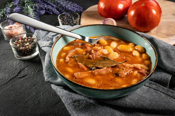 Beans with tomato sauce, bacon and sausage.