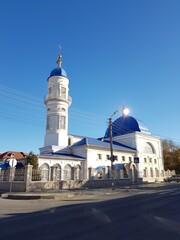 Fototapeta na wymiar Muslim mosque with blue domes and golden crescent