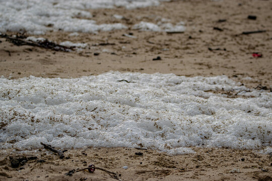 Vendée, France; January 23, 2021: sea foam, or seawater foam, covered a beach in Brétignolles Sur Mer, caused by the strong wind.

