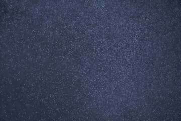 Abstract festive background with selective focus. Bright particles on dark background. Splashes,...