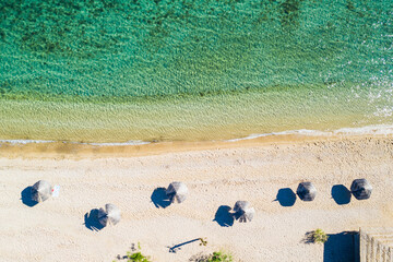 Fototapeta na wymiar Beautiful sand beach wit parasols. Overhead aerial view. Adriatic sea in Croatia on Pag island.