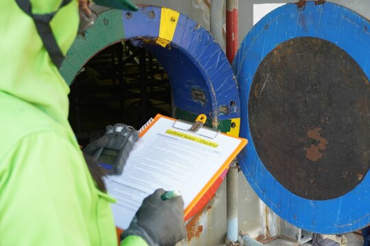 (Focus on Main hole) Construction supervisor use checking to inspect and gas including oxygen record before entering work in confined spaces high risk work construction site.
