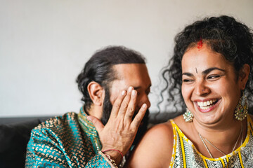 Cheerful indian wife and husband having fun together at home - Focus on woman face