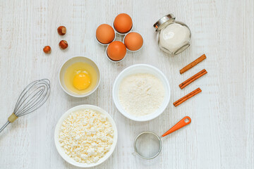 Composition with baking ingredients and cooking utensils on a light background top view