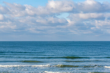 Fototapeta premium Winter seascape with Baltic Sea waters, horizon and cloudy sky in Kaliningrad region, Russia