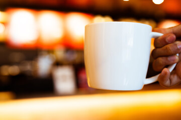 Handed white hot coffee latte cup for background